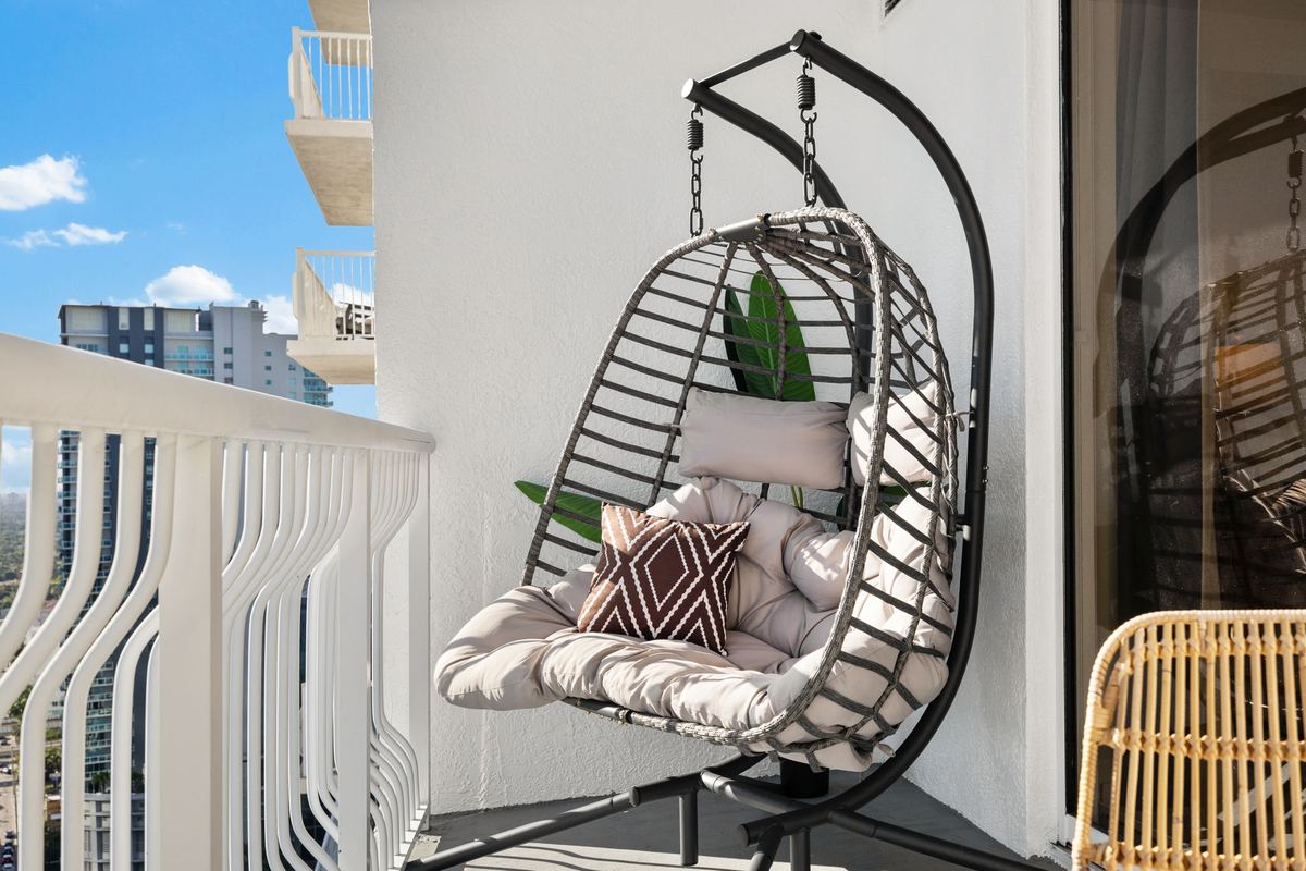 Hanging egg chair on the balcony against the skyline
