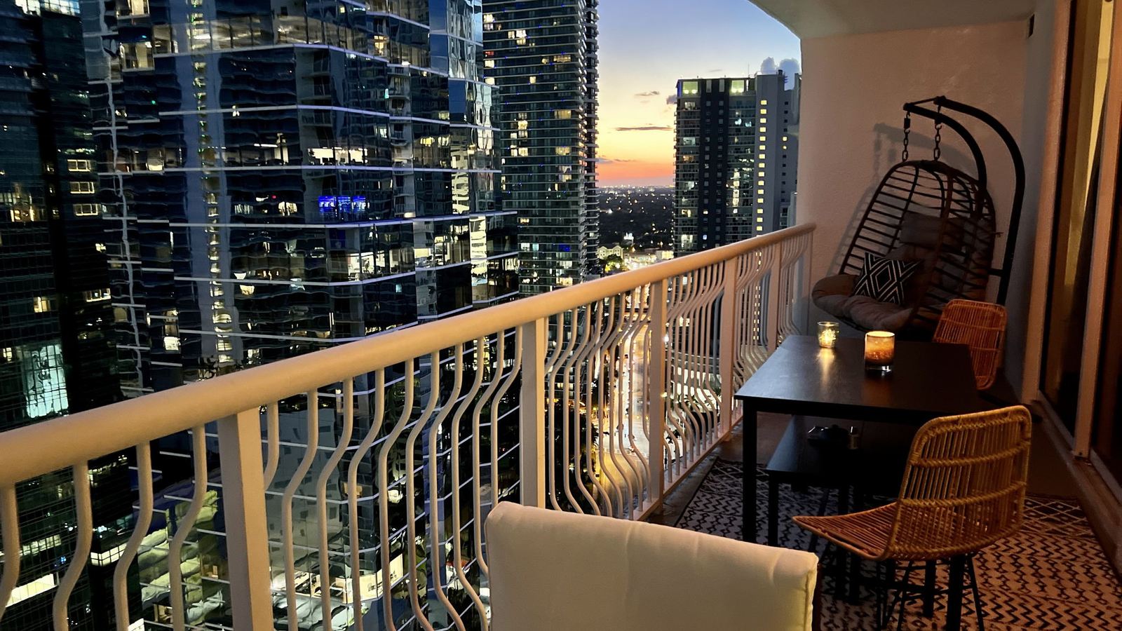 Balcony at dusk with the Brickell towers lit across the water