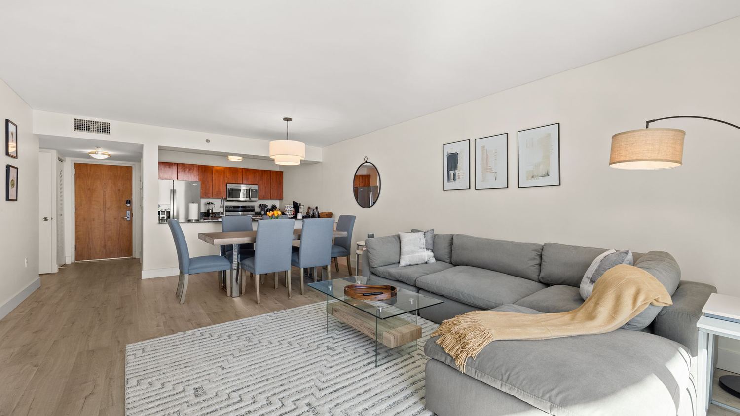 Open-plan living and dining room with sectional and six-seat table